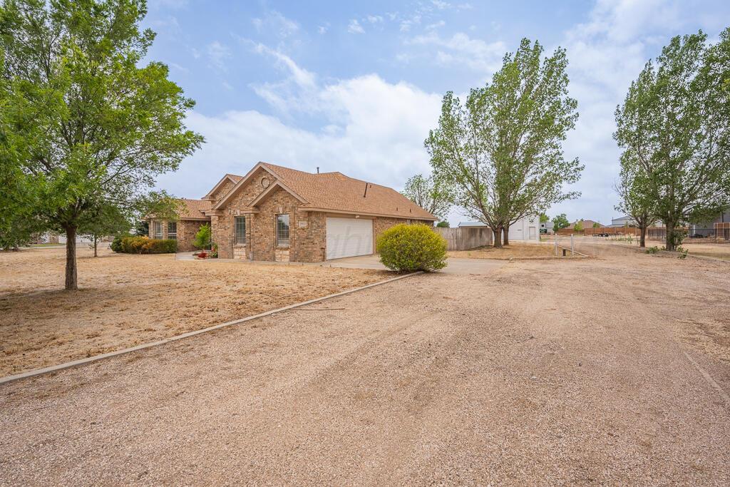 19933 Indian Spring Trail Bushland, TX 79124 - Photo 2 of 32 a view of large tree in front of a house