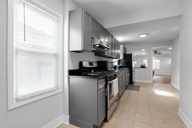 a large kitchen with stainless steel appliances lots of counter top space