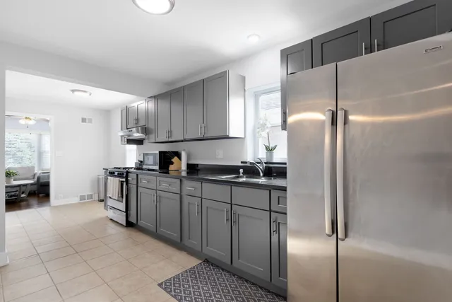 a kitchen with stainless steel appliances granite countertop a refrigerator and a sink