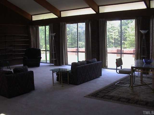 5405 Castlebrook Drive Raleigh, NC 27604 - Photo 3 of 12 a living room with furniture and large windows