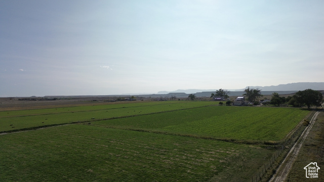 Undisclosed Address Elmo, UT 84521 - Photo 13 of 16 View of green lawn with a mountain view, a view of countryside, and agricultural plots