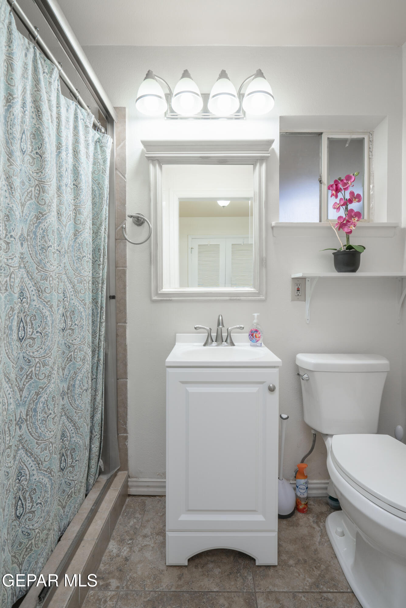 404 Butte Circle El Paso, TX 79902 - Photo 12 of 24 a bathroom with a sink a toilet and a mirror