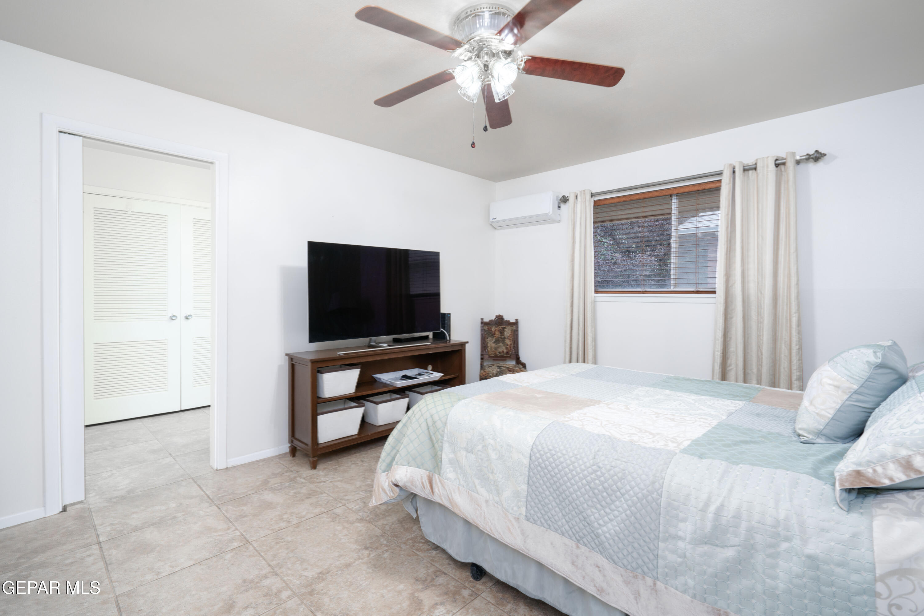 404 Butte Circle El Paso, TX 79902 - Photo 14 of 24 a bedroom with a bed and a flat screen tv