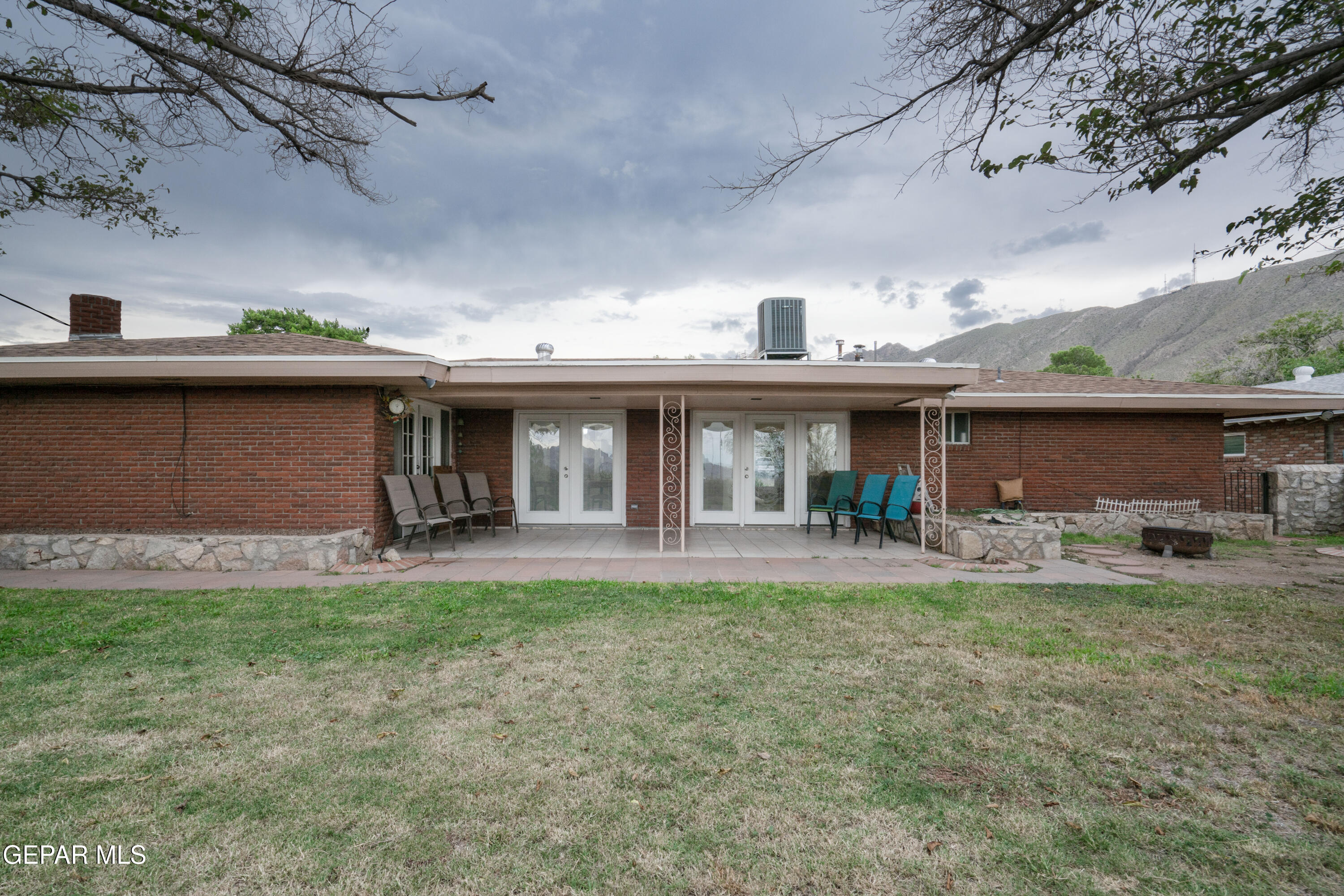 404 Butte Circle El Paso, TX 79902 - Photo 21 of 24 a front view of a house with a garden and patio