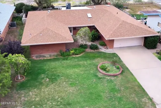 an aerial view of a house with garden space and a street view