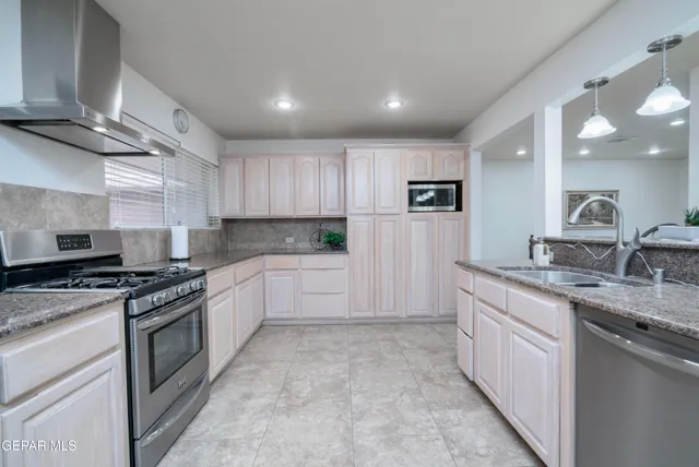 a kitchen with a sink stove and cabinets