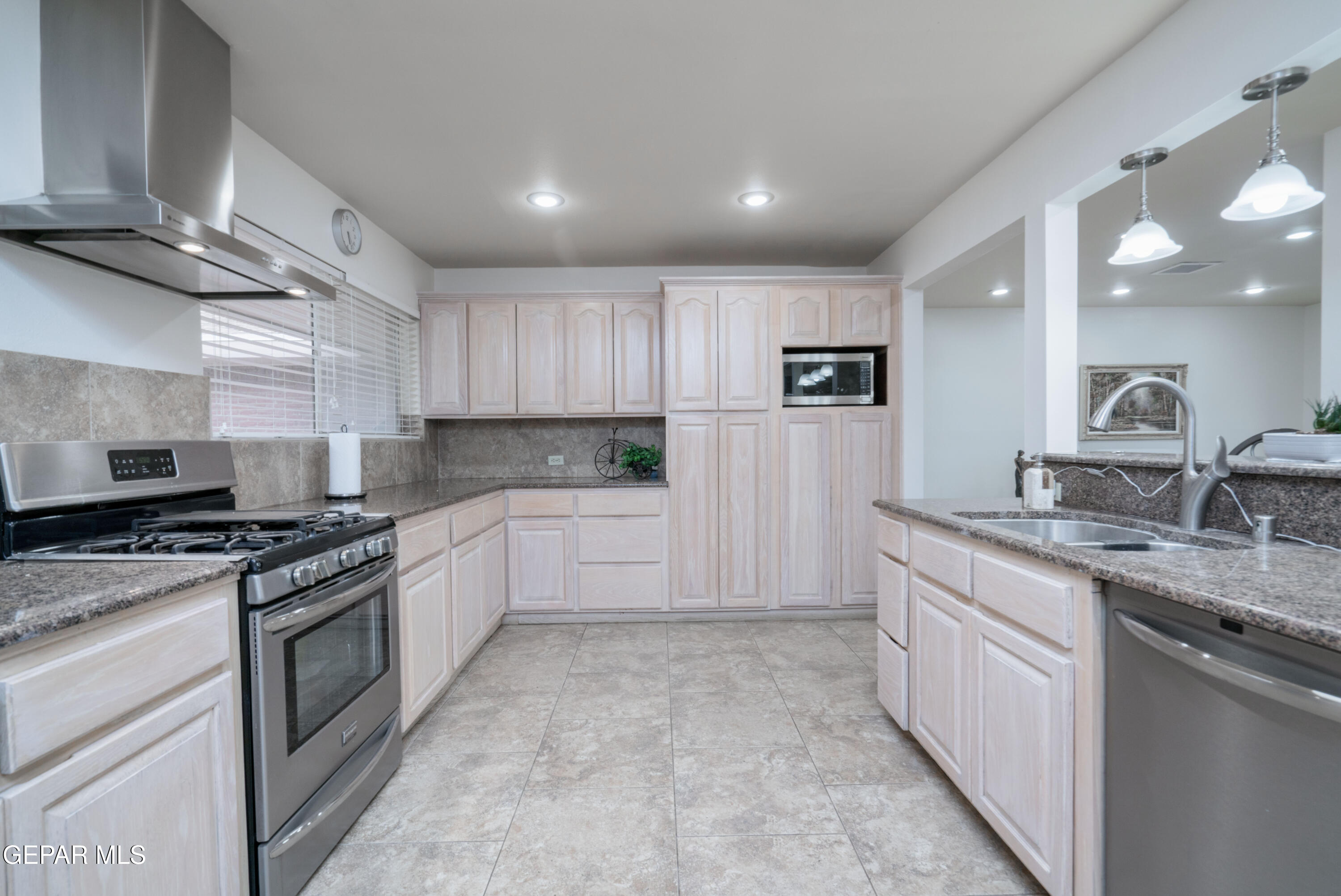 404 Butte Circle El Paso, TX 79902 - Photo 8 of 24 a kitchen with a sink stove and cabinets