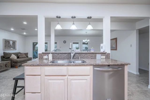 a bathroom with a granite countertop sink a mirror and a vanity