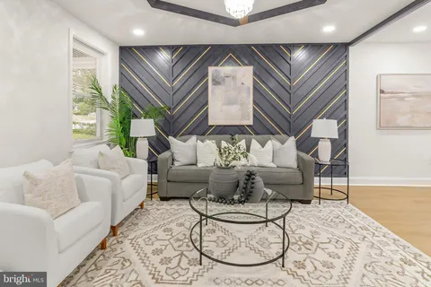 a living room with furniture and a chandelier