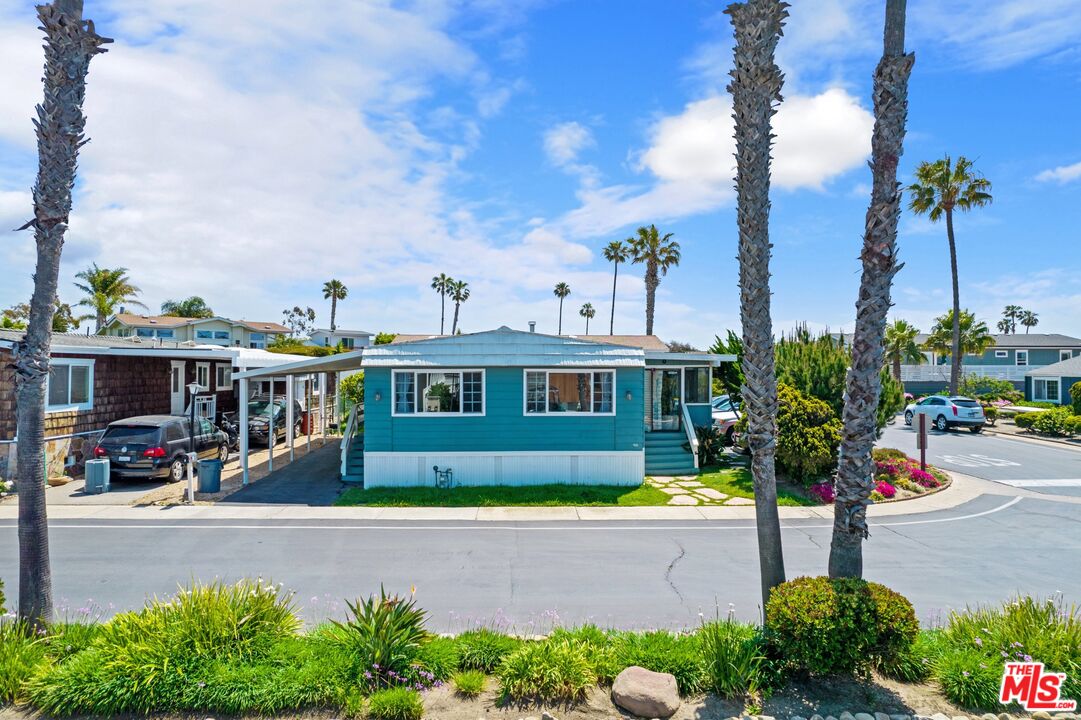 29500 Heathercliff Road, Unit 5 Malibu, CA 90265 - Photo 1 of 17 a front view of a house with a garden and swimming pool