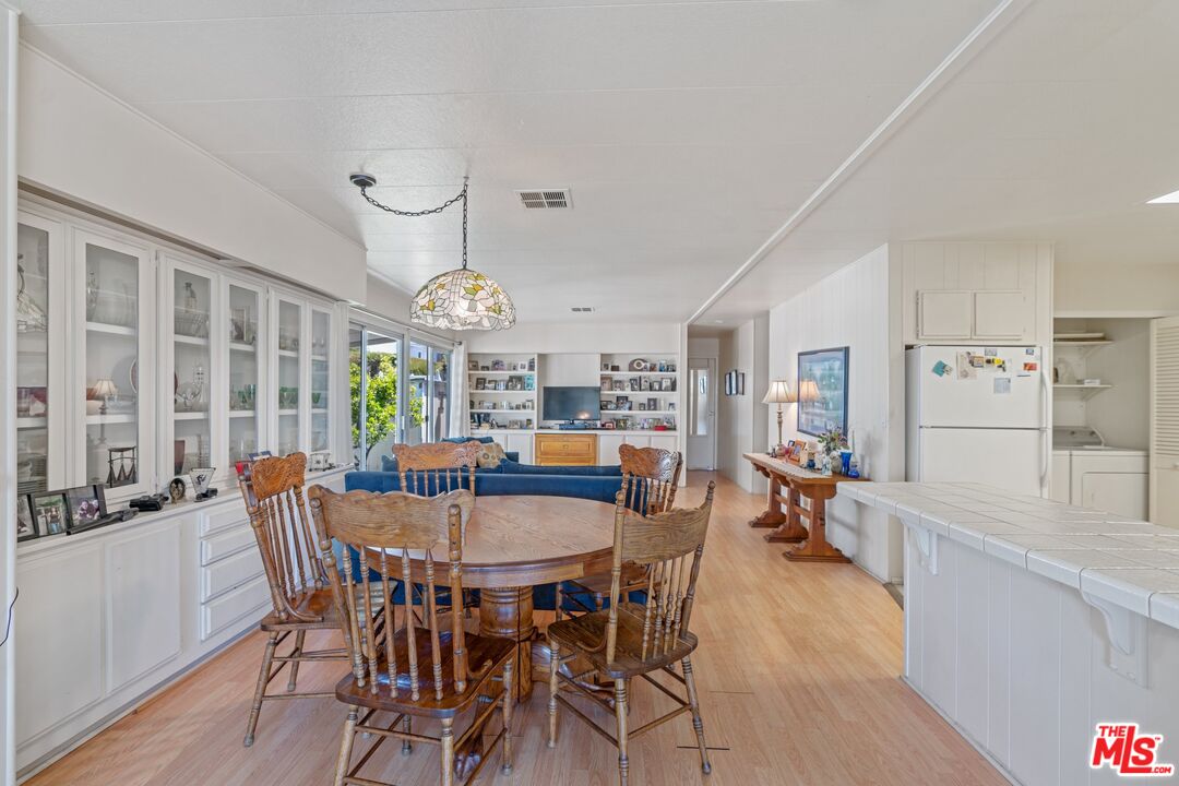 29500 Heathercliff Road, Unit 5 Malibu, CA 90265 - Photo 3 of 17 a view of a dining room with furniture window and wooden floor