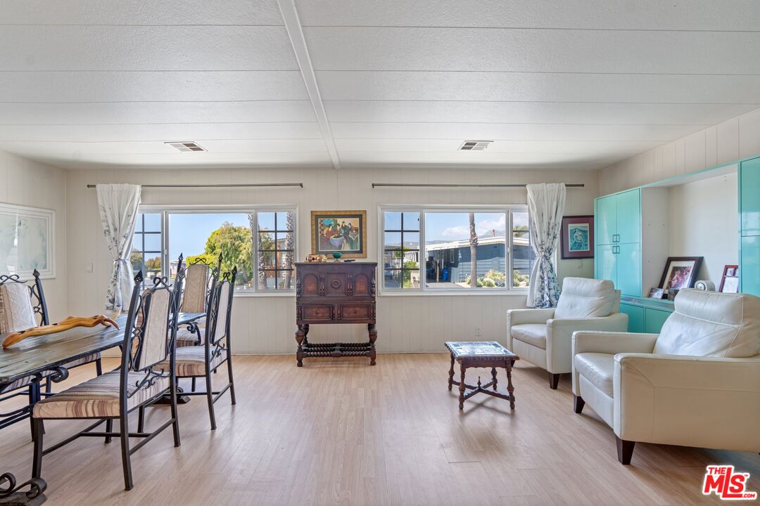 29500 Heathercliff Road, Unit 5 Malibu, CA 90265 - Photo 4 of 17 a living room with furniture and a floor to ceiling window