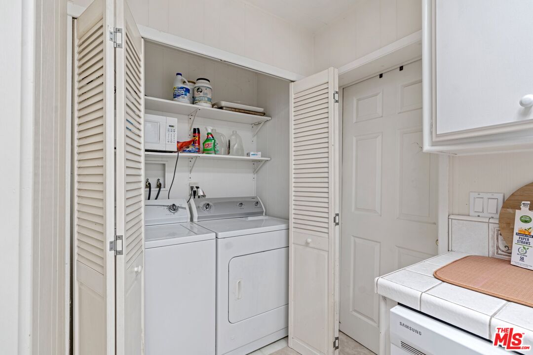 29500 Heathercliff Road, Unit 5 Malibu, CA 90265 - Photo 6 of 17 a room with a cabinets and washer