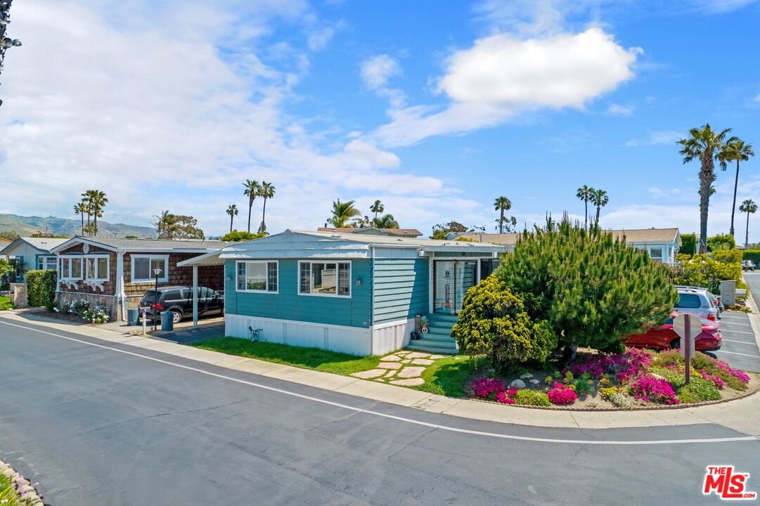 29500 Heathercliff Road, Unit 5 Malibu, CA 90265 - Photo 9 of 17 a front view of a house with a yard and potted plants