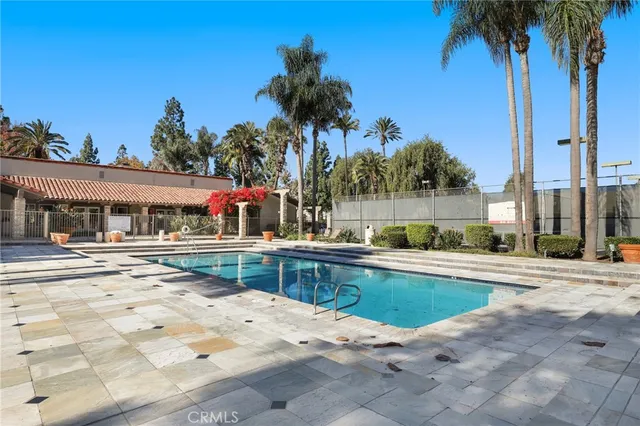 a hallway with white cabinets and wooden floor