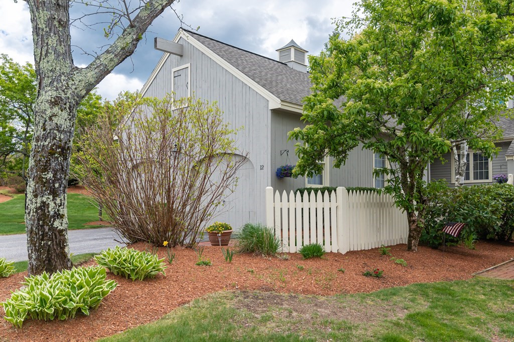 12 Wynridge Road, Unit 12 Windham, NH 03087 - Photo 3 of 40 a view of a house with a tree in the yard