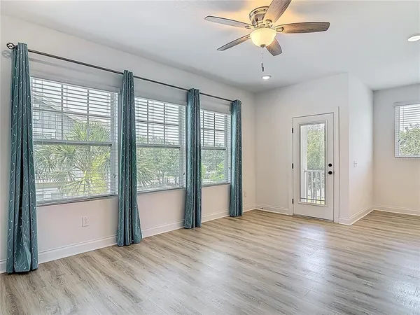 a kitchen with a refrigerator and white cabinets