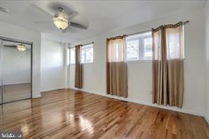 1217 North 65th Street, Unit 1 Philadelphia, PA 19151 - Photo 5 of 9 wooden floor in an empty room with a window