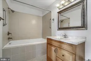 a bathroom with a sink vanity tub and a mirror