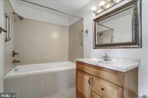 1217 North 65th Street, Unit 1 Philadelphia, PA 19151 - Photo 6 of 9 a bathroom with a sink vanity tub and a mirror