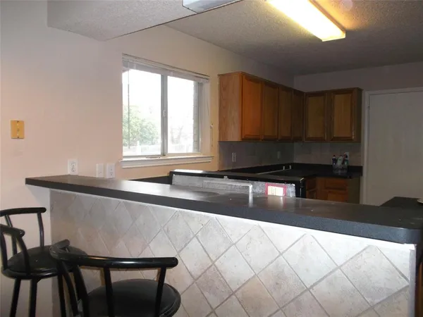a kitchen with kitchen island sink and stove