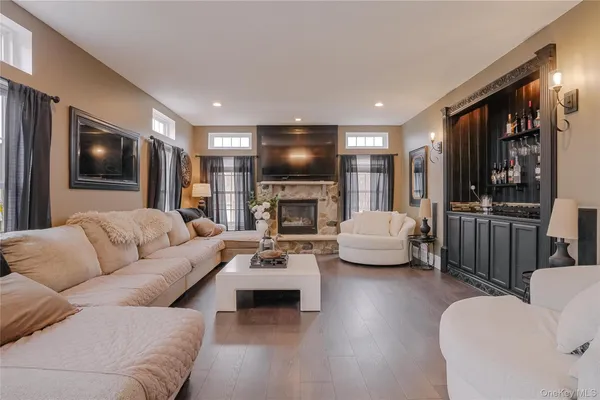 a living room with fireplace furniture and a flat screen tv