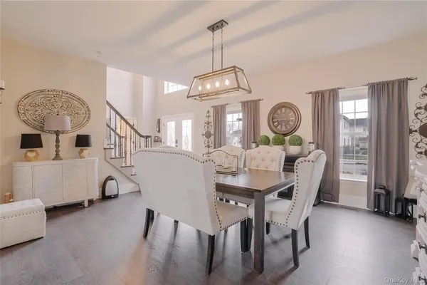 a view of a a dining room with furniture window and wooden floor