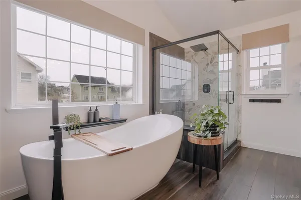 a bathroom with a sink and mirror with bathtub