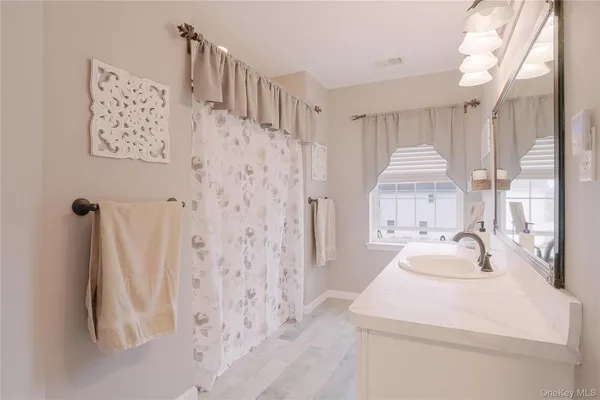 a bathroom with a sink a toilet and a shower