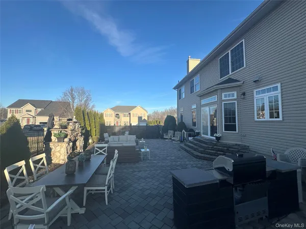 a view of a patio with couches table and chairs and potted plants