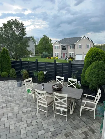 a view of a patio with table and chairs and potted plants