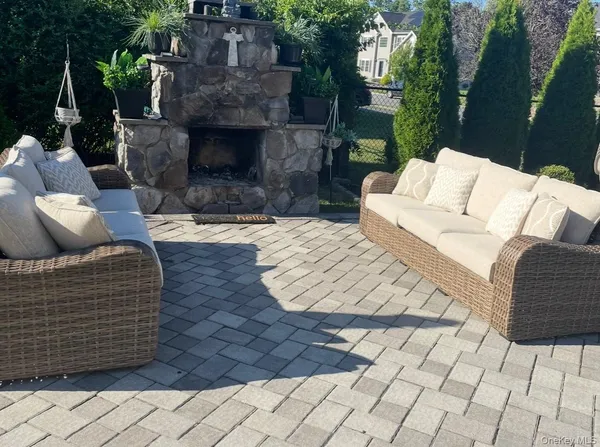 a outdoor living space with furniture and a fireplace
