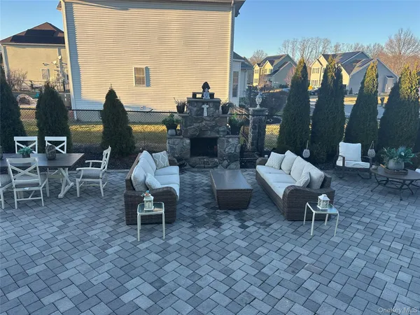 a view of a patio with dining table and chairs