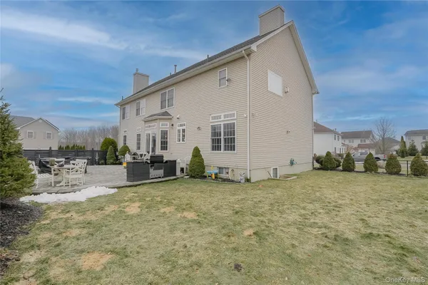 a view of a house with backyard porch and sitting area