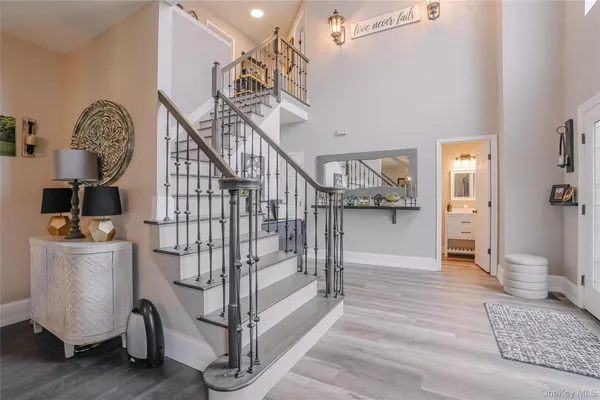 a view of entryway and hall with wooden floor