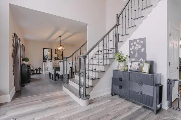 a view of entryway dining room and hall with wooden floor
