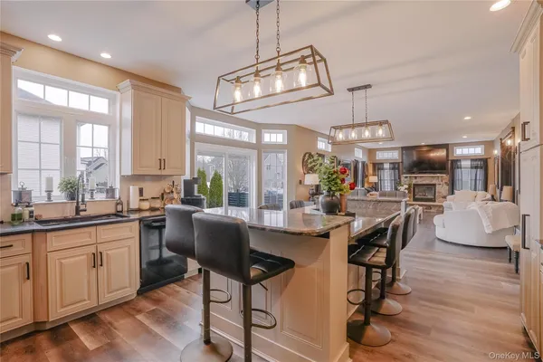 a very nice looking open dining room with kitchen island a table and a couch