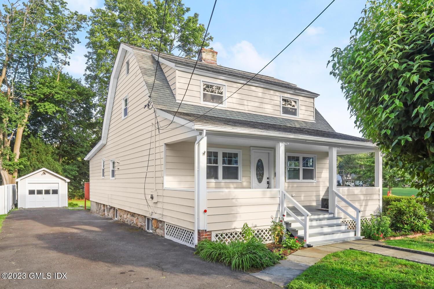 20 Cross Lane Cos Cob, CT 06807 - Photo 2 of 24 a view of a white house with a small yard and large tree