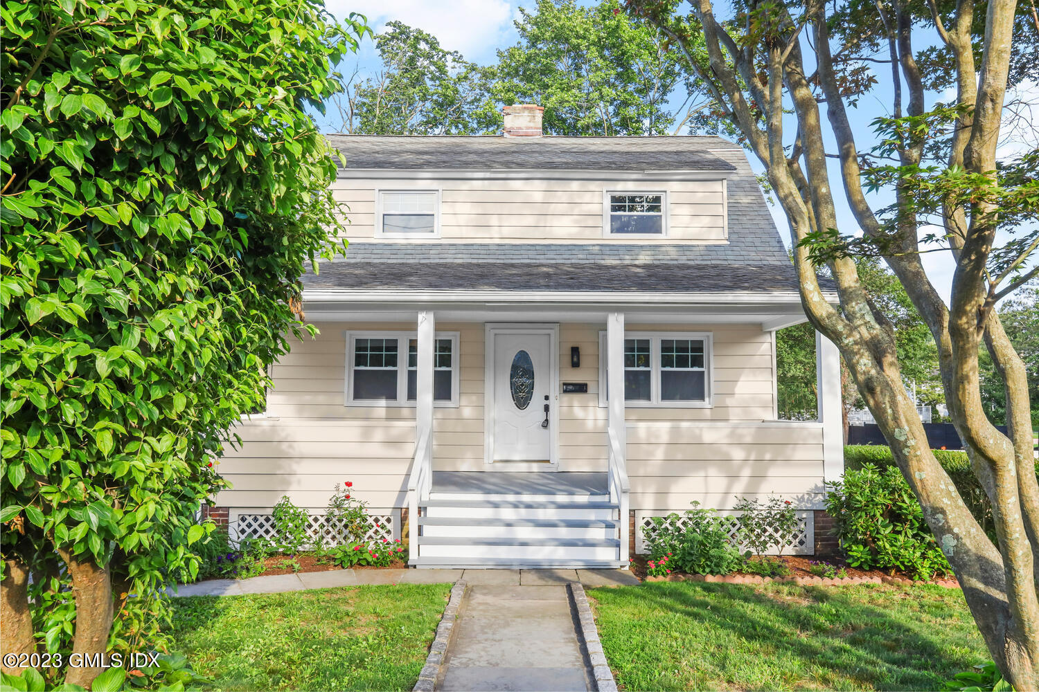 20 Cross Lane Cos Cob, CT 06807 - Photo 3 of 24 a front view of a house with a yard