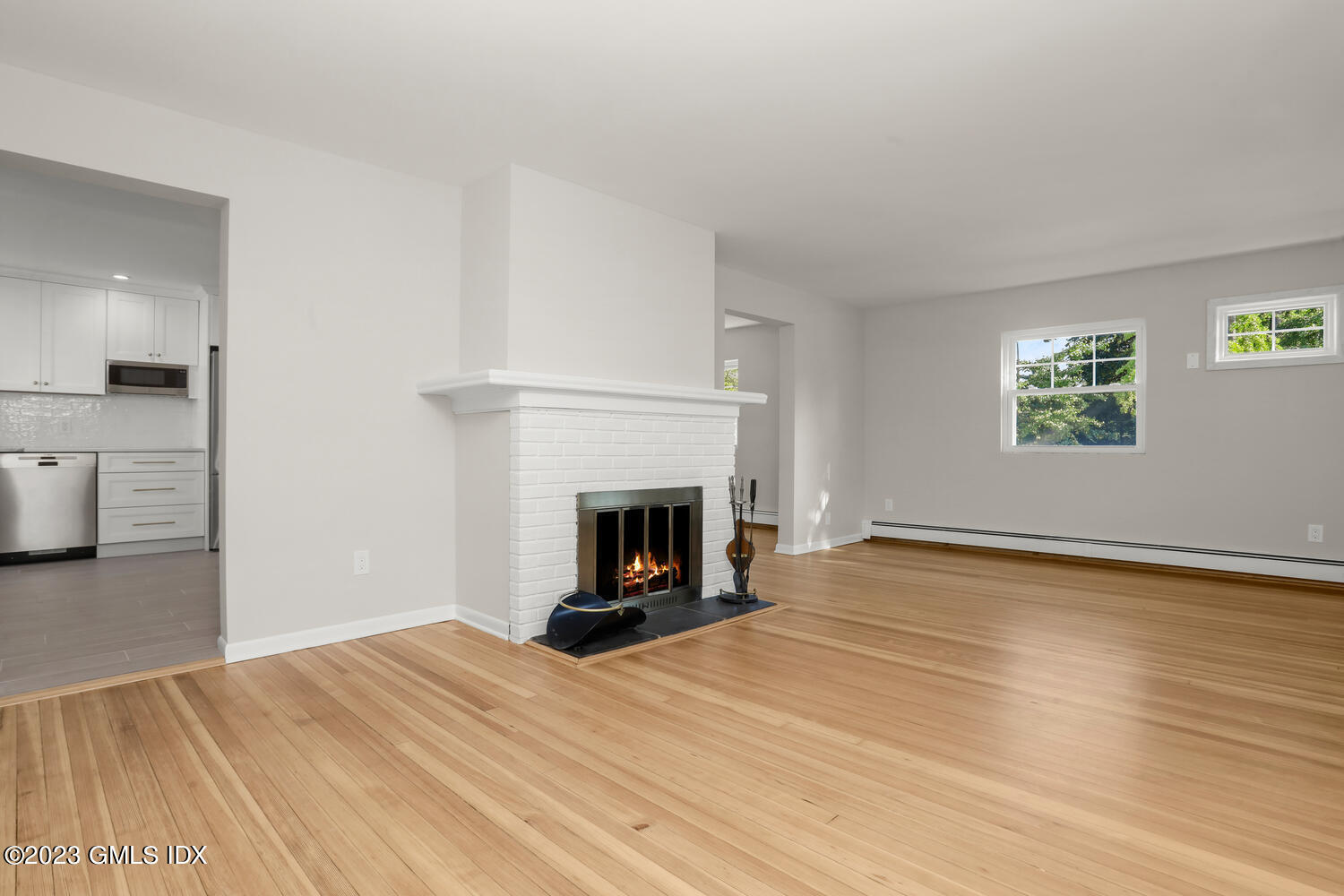 20 Cross Lane Cos Cob, CT 06807 - Photo 5 of 24 a view of empty room with wooden floor and fireplace