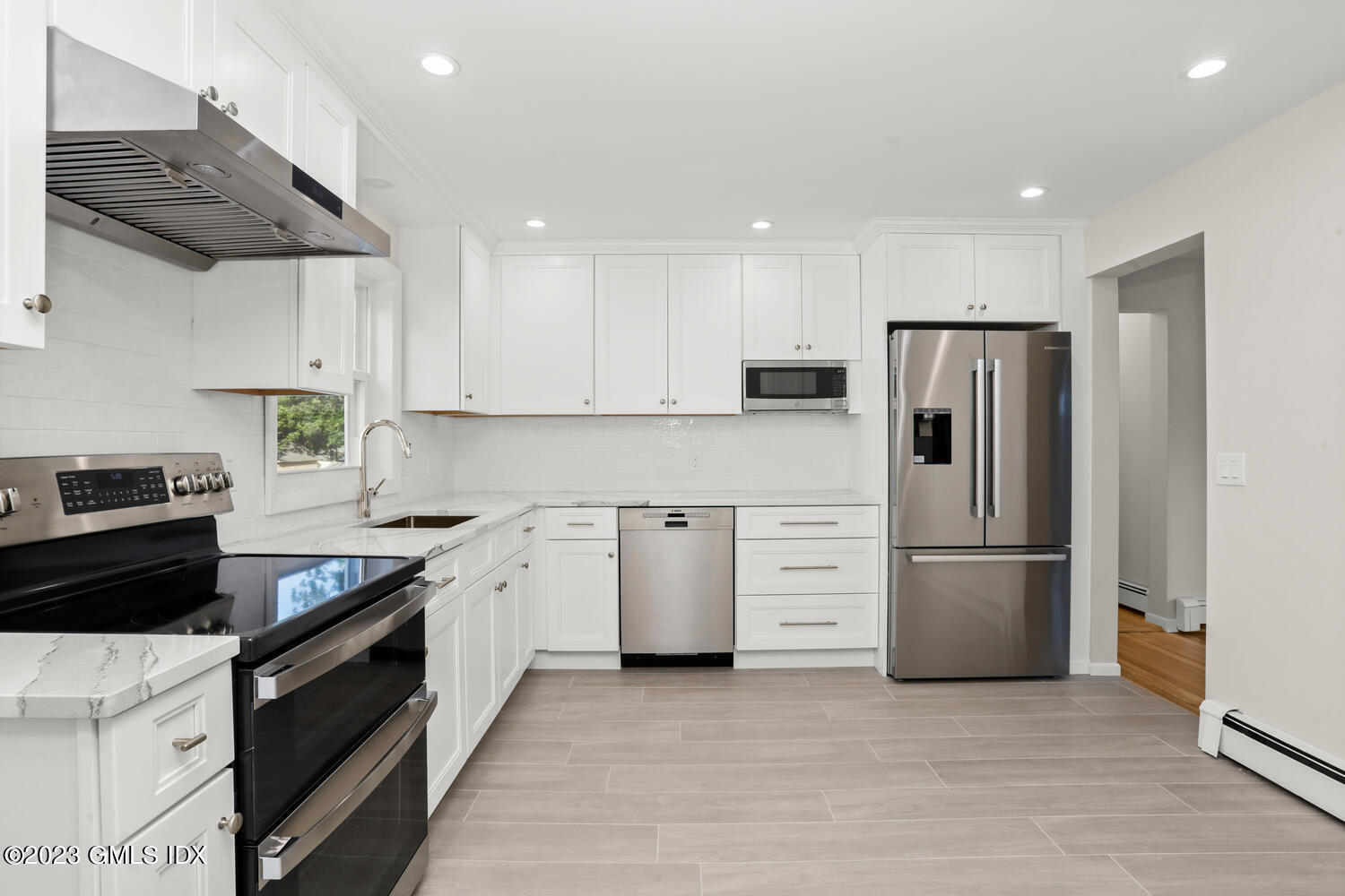 20 Cross Lane Cos Cob, CT 06807 - Photo 7 of 24 a kitchen with stainless steel appliances a refrigerator sink and stove