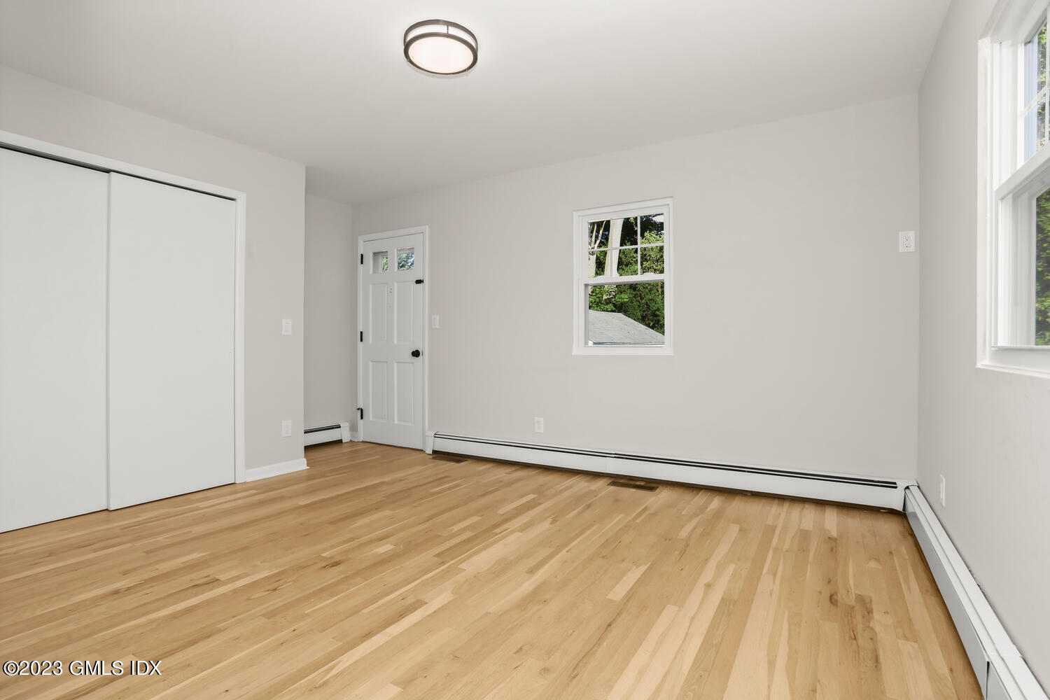 20 Cross Lane Cos Cob, CT 06807 - Photo 9 of 24 a view of an empty room with wooden floor and a window