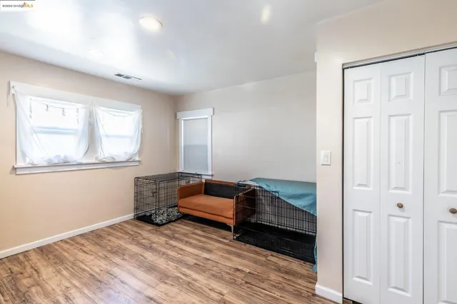 a kitchen with wooden floor and electronic appliances