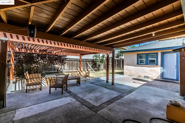 a patio with wooden furniture