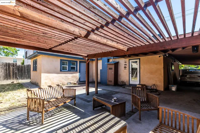 a view of a house with backyard and sitting area