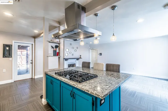 a living room with stainless steel appliances kitchen island granite countertop furniture and a kitchen view