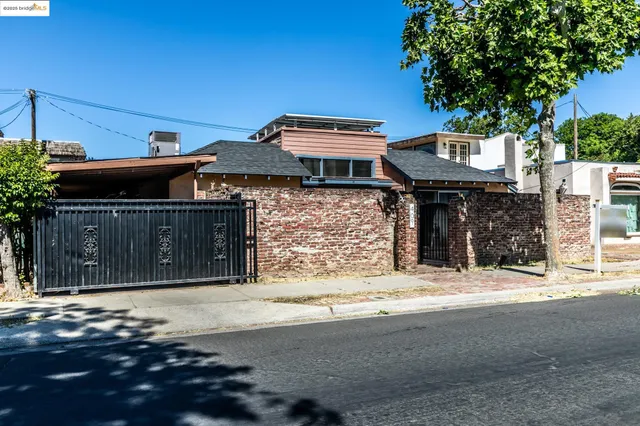 a front view of a house with a tree