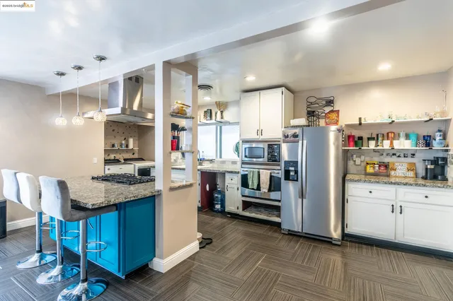 a kitchen with stainless steel appliances granite countertop a sink stove and cabinets