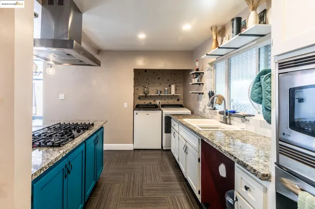 a kitchen with stainless steel appliances a refrigerator and a stove