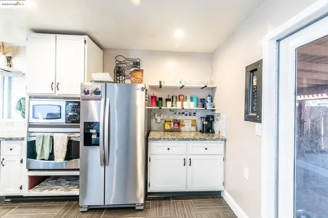 a view of a hallway with a kitchen